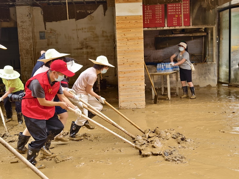黔東南州局“黔稅先鋒”志愿隊(duì)伍支援榕江，圖為州局志愿者清理淤泥。